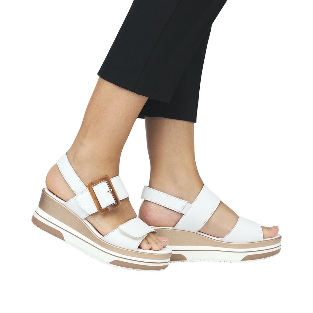 Model wearing white Remonte D1P50 Platform Wedge sandals, styled with black pants for a chic summer look with comfort.