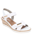 White backstrap sandal with gold bar details, tan Remonte logo'd footbed, white scratched faux cork midsole and white outsole.
