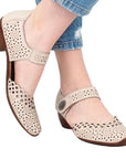 Beige  leather Mary-Jane heels worn with jeans.