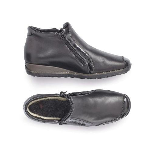 Pair of Black leather ankle boots with side zipper, patent accents, detail stitching, wool lining and wedge heel.