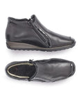 Pair of Black leather ankle boots with side zipper, patent accents, detail stitching, wool lining and wedge heel.