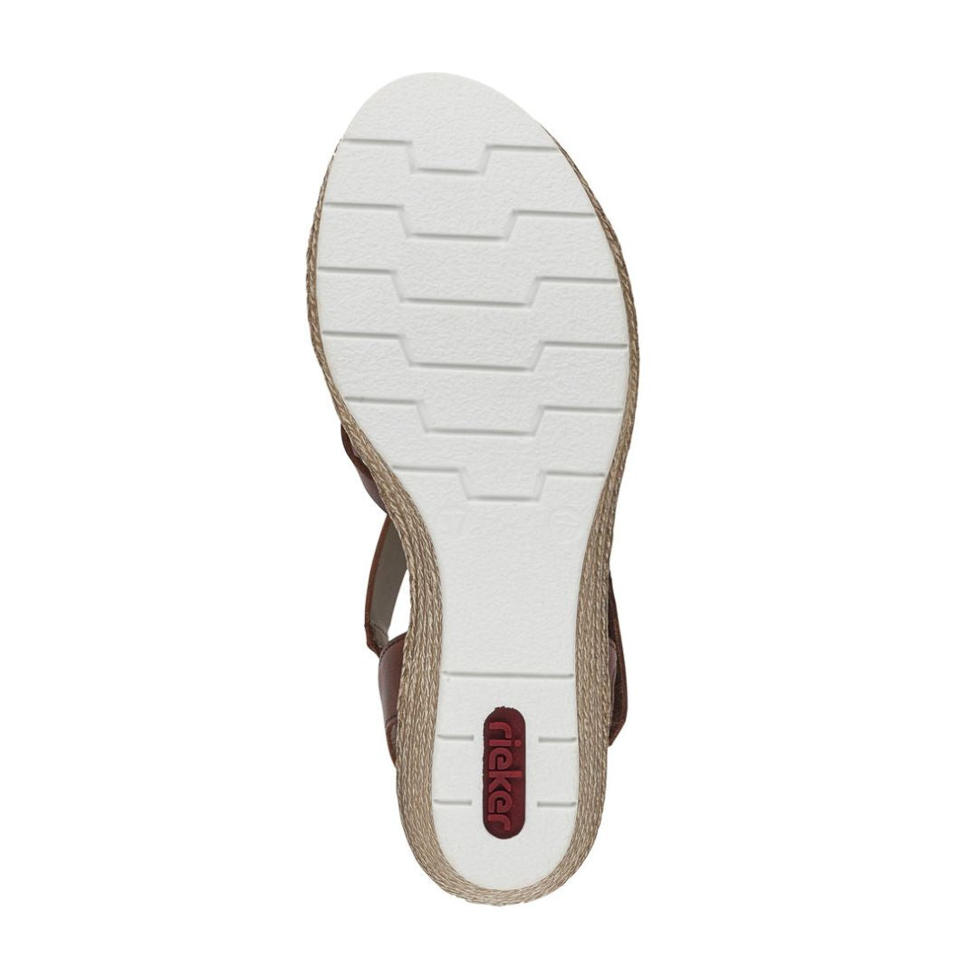 Outsole view of Women's Rieker 61937 sling-back platform wedge featuring white, shock-absorbing tread for enhanced grip and comfort.