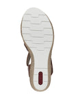 Outsole view of Women's Rieker 61937 sling-back platform wedge featuring white, shock-absorbing tread for enhanced grip and comfort.