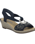 Navy slingback wedge sandal with beaded embellishments, silver medallion, faux espadrille midsole and a tan Rieker logo'd footbed.