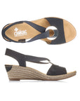 Pair of Black slingback faux espadrille wedge sandals with elastic side straps, silver medallion, tan Rieker logo'd footbed and brown outsole.