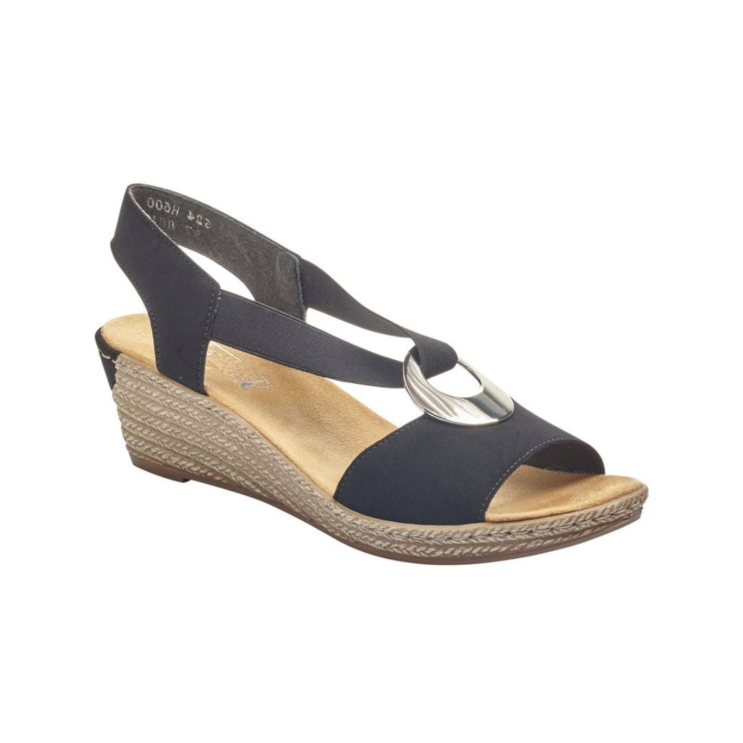 Tan wedge sandal with black upper straps connecting to toe with silver circle detail