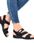 Model wearing black Backstrap Leather Sandals styled with jeans.