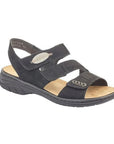 Backstrap Leather Sandal in black with 3 Velcro straps across vamp, pewter accents, tan Rieker logo'd footbed and black outsole.