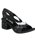 Women's Rieker 64683 Sling-Back Heel with durable block heel and floral pattern, featuring a silver circle medallion on the front strap.