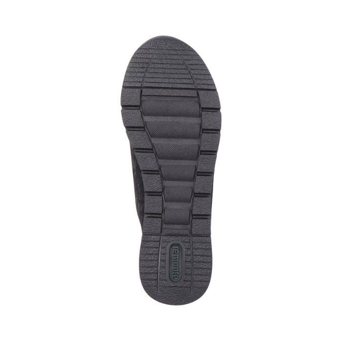 Black rubber outsole of women's sneaker with green Remonte logo on heel.