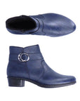 A pair of navy Rieker ankle boots with circle buckle detail, side zipper, light black felt lining and low black stacked heel.