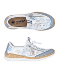 Pair of A white Rieker bungee cord slip-on sneakers with decorative leaf perforations and blue accents throughout upper, decorative side zipper, faux cork midsole and white outsole.