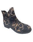 A single ankle boot with a dark charcoal gray base and a beige floral pattern, featuring a side zipper and a low block heel.