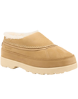 A tan slip-on clog-style shoe with a cream-colored faux shearling lining and a thick cream outsole.