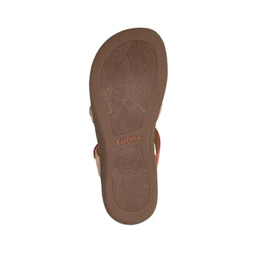 Outsole view of Women's Taos Prize 4 Slide Sandal in beige, featuring textured rubber sole for traction and durability.