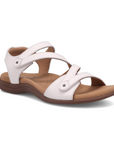 White backstrap sandal with two Velcro cross straps, tan Taos logo'd footbed and dark brown outsole.