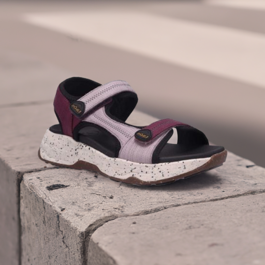 Taos Super Side Backstrap Sandal displayed outdoors on concrete, showcasing comfort-focused design and adjustable straps for active wear.