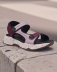 Taos Super Side Backstrap Sandal displayed outdoors on concrete, showcasing comfort-focused design and adjustable straps for active wear.