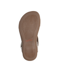 Leaf tread patterned outsole with orange Taos logo in middle.