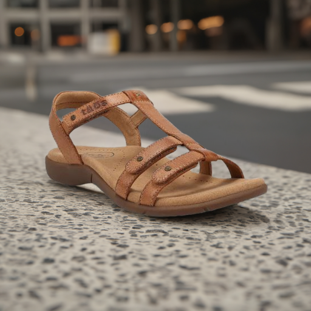 Bronze Women's Taos Trophy 2 Backstrap Leather Sandal displayed outdoors, ideal for stylish and supportive everyday use.
