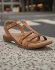 Bronze Women's Taos Trophy 2 Backstrap Leather Sandal displayed outdoors, ideal for stylish and supportive everyday use.