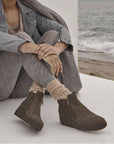 Model wearing Vionic Uptown Sur Ankle Boots styled with cozy fall outfit, highlighting the boot’s versatile and fashionable waterproof design.