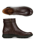 Pair of brown ankle boots with a zipper, side buckle detail and a black outsole.