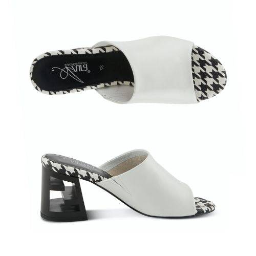 A pair of white open toe leather block heel sandals with black and white checkered footbed. Block heel has chunky "Z" shaped.