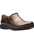 Bronze slip on shoe with detailed overlap upper featuring side zipper and black durable outsole