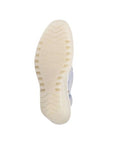 Outsole view of light blue FLY London Yeay Wedge Sandal with cream rubber sole and FLY London branding for traction.