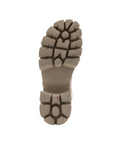 Deep lugged block heel outsole in tan of a sandal.
