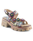Cool tone colored backstrap sandal with floral decorations, grey and tan footbed, and a paint stroke patterned lugged platform block heel outsole.