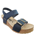 Navy wedge sandal with Velcro straps, gold bar details on toe strap, cork midsole and beige outsole.