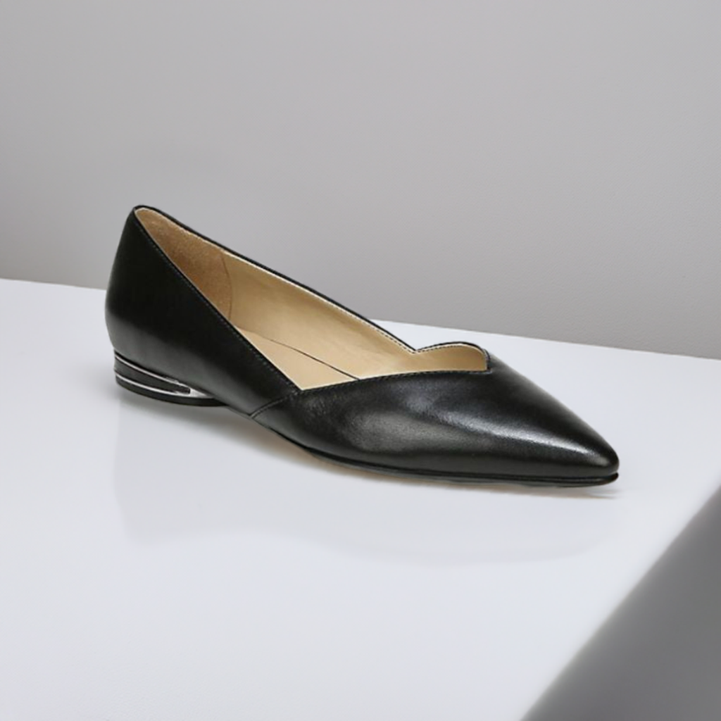 Women's Naturalizer Havana black leather flat displayed on a white surface, highlighting its elegant pointed toe and modern low heel.