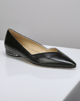 Women's Naturalizer Havana black leather flat displayed on a white surface, highlighting its elegant pointed toe and modern low heel.