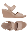 Pair of Beige wedge sandals with Velcro strap and Naturalizer logo on footbed.
