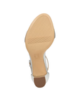 Light treaded tan outsole of block heel sandal with Naturalizer logo stamped in middle.