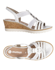 Pair of Silver slingback wedge sandals with gladiator style straps, shimmery pearled charm t-strap, tan Remonte logo'd footbed, cork wedge and white outsole.