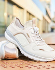 Women's Rieker L3294 Slip-On Sneakers styled outdoors, showcasing their casual design, metallic heel detail, and comfort-focused build.
