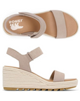 Top and side view of taupe Women's Sorel Cameron Wedge Sandal showing suede upper, EVA footbed, and textured wedge heel design.