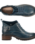 Pair of Blue leather lace-up boots with tan Taos logo'd footbed, a buckle at heel and brown low block heeled outsole.