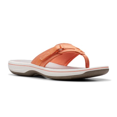 Breeze Sea thong sandal in tangerine. Light orange upper with adjustable velcro strap and fabric toe post. Footbed is grey, midsole is white, outsole is taupe.