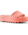 Pool Party Slide Sandal in Coral. A solid colour, light pink sandal with a 1.5 inch platform outsole, which has deep grooves.