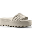 Pool Party Slide Sandal in Dove. A solid coloured, light taupe sandal with a 1.5 inch platform outsole, designed with deep grooves.