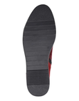 Black rubber light treaded outsole of ankle boot.