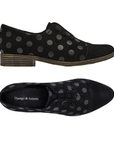Pair of black suede oxford-style shoes with metallic black polka dots, button elastic lacing system, Django and Juliette logo'd footbed and low stacked heel.