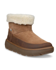 A brown suede ankle boot with a thick brown lugged outsole and a fluffy cream faux fur collar.