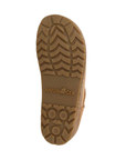 Tan treaded outsole of ankle boot with Haflinger logo stamped in middle.