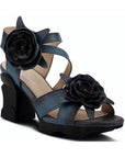 Heeled sandals in hand-painted deep blue leather with 3D flower accents and a sculpted black wedge heel.