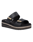 Black slide sandal with two Velcro straps, gold bar accents on each strap, black Remonte logo'd footbed, and a black platform with brown accents.